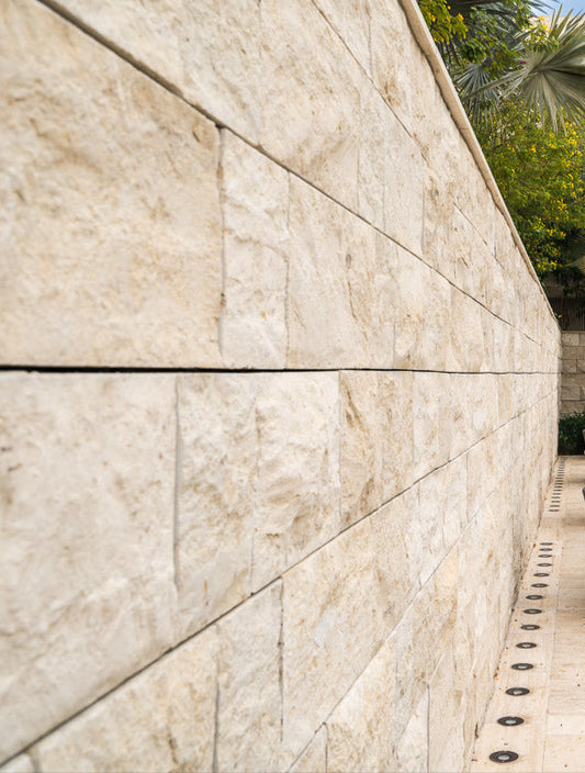 Outdoor patio area with stone wall